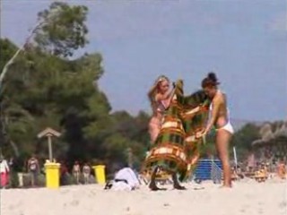 Two topless lesbian girls on the beach