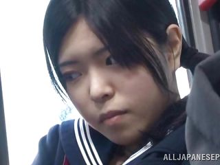 The cute asian schoolgirl got the wrong chair, or perhaps the right one because she is sitting near a pervert. The guy doesn't cares that the buss is filled with people, he just takes out his dick and puts her to jerk him. It looks like the schoolgirl is not so innocent because this little bitch masturbates too!